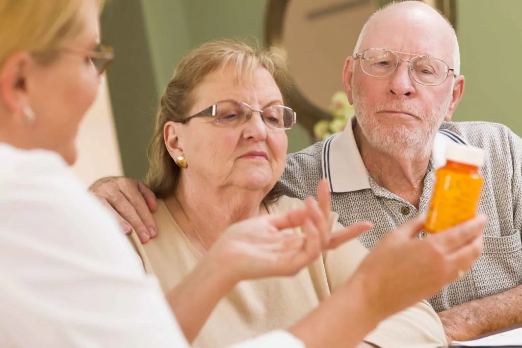 doctor explaining medication to senior patients