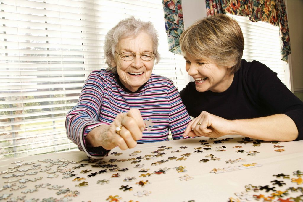 two women doing a puzzle together
