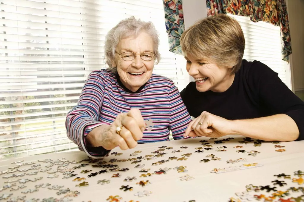 two women doing a puzzle together