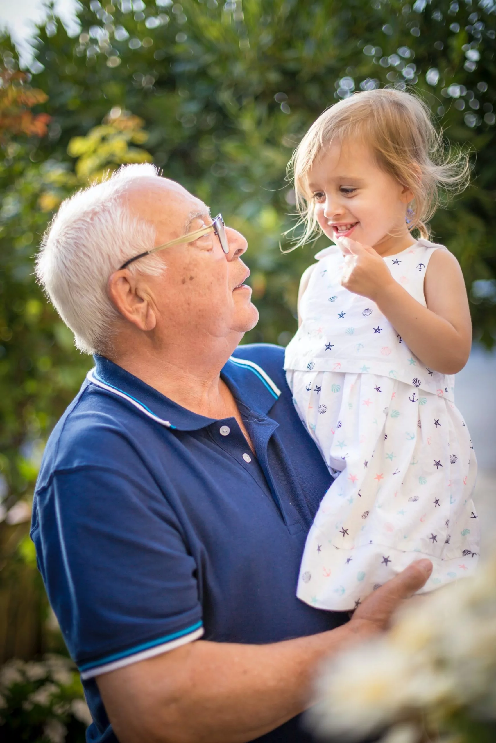 Senior man holding a toddler