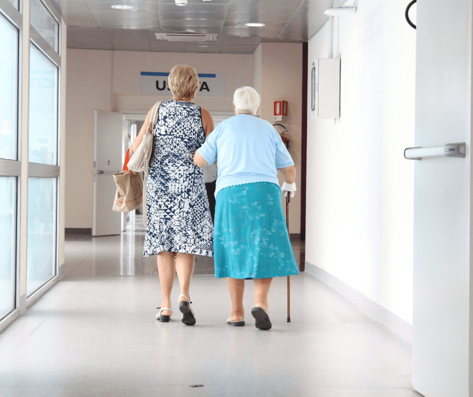 Two women walking down a hallway